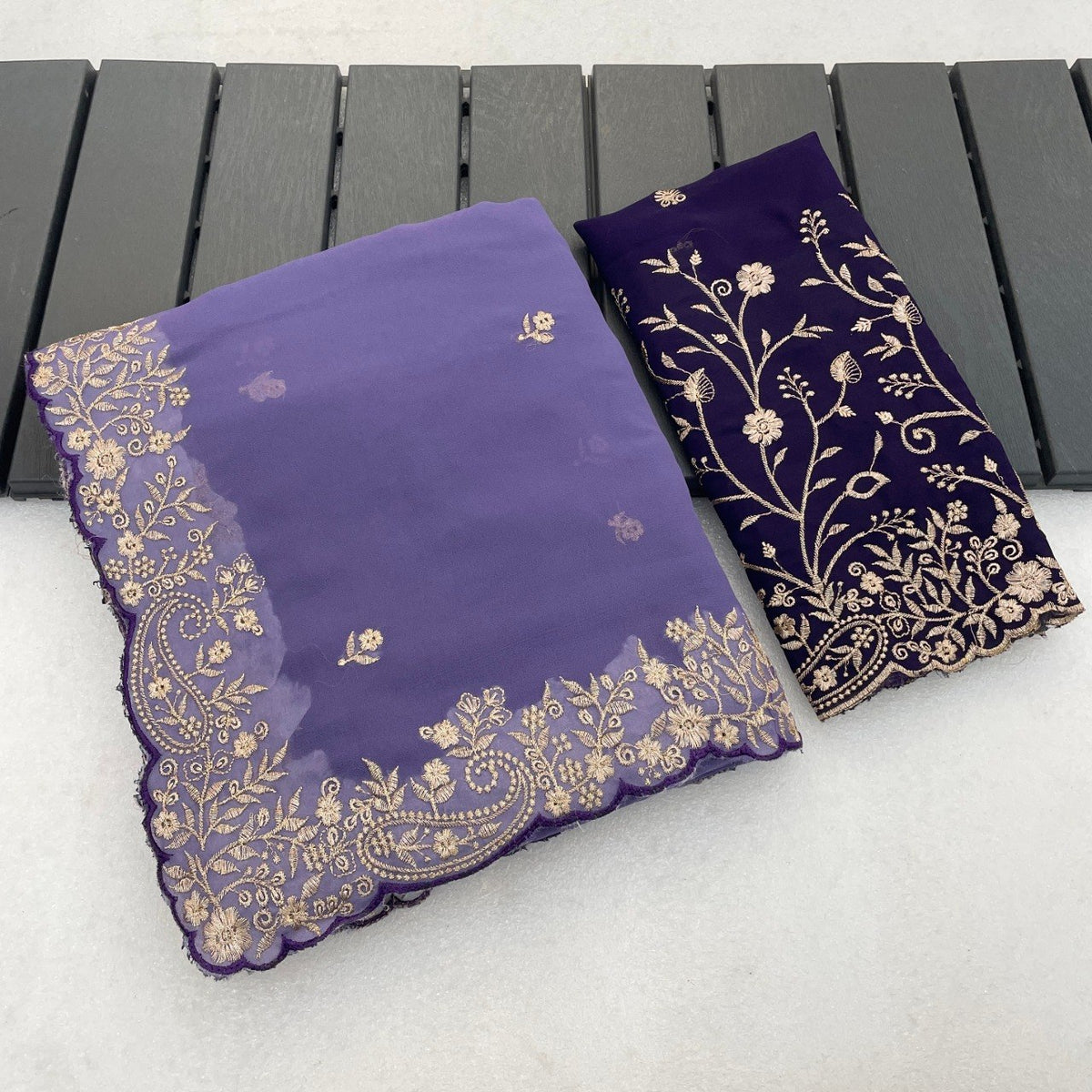 Lavender purple Georgette saree flatlay with floral embroidered border and matching blouse — Chandrikas