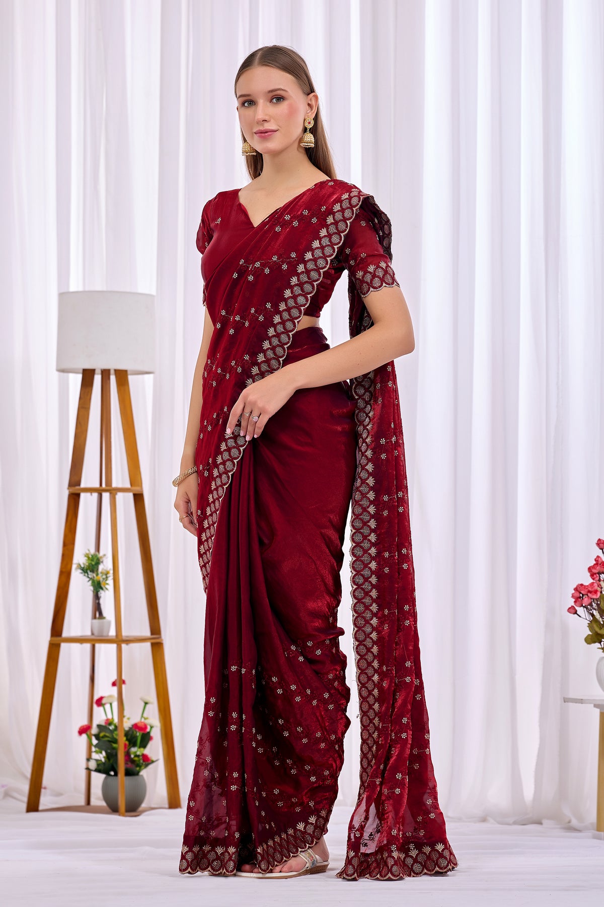 Stylish pose in Maroon satin floral thread work designer border saree showing embellished border and pallu — Chandrikas