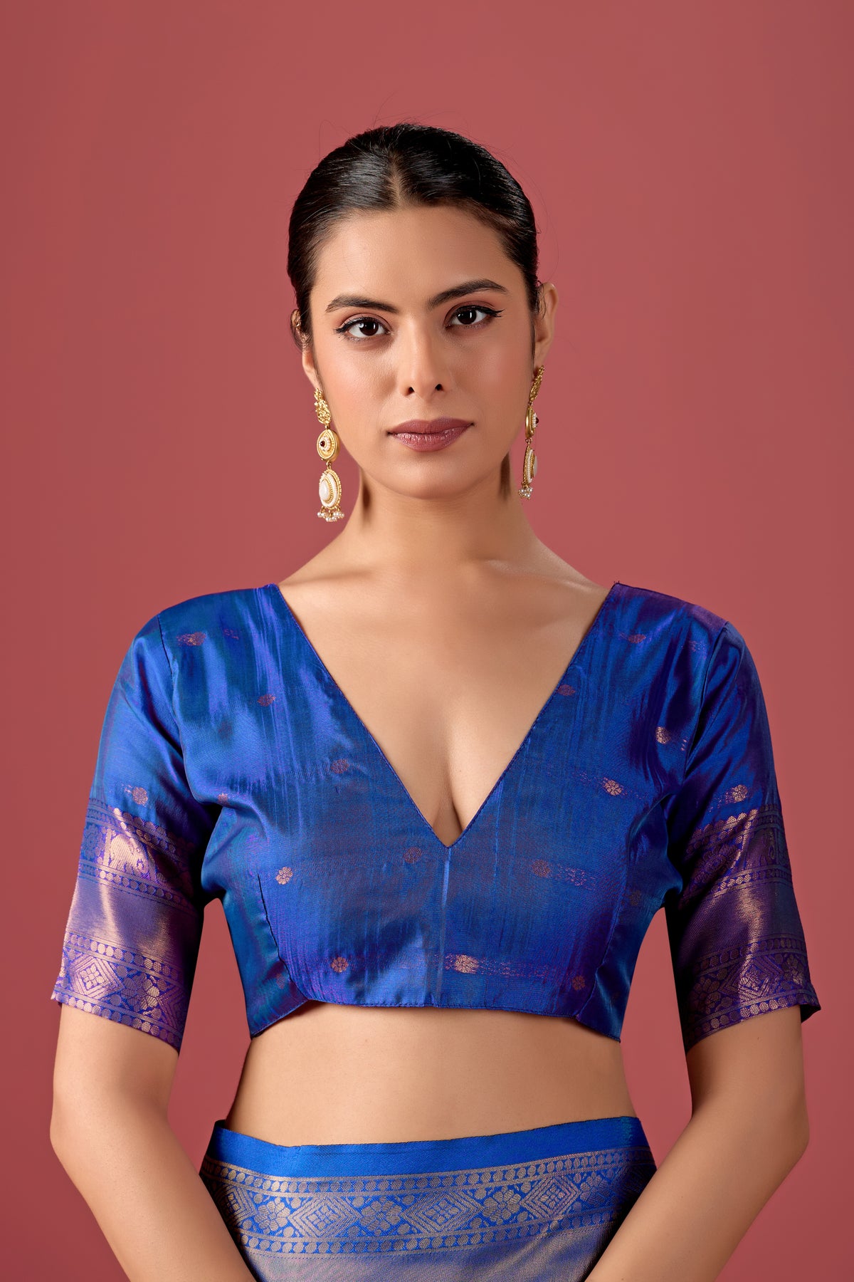Woman in close pose wearing rama green dark blue Banarasi silk checks pattern saree — Chandrikas