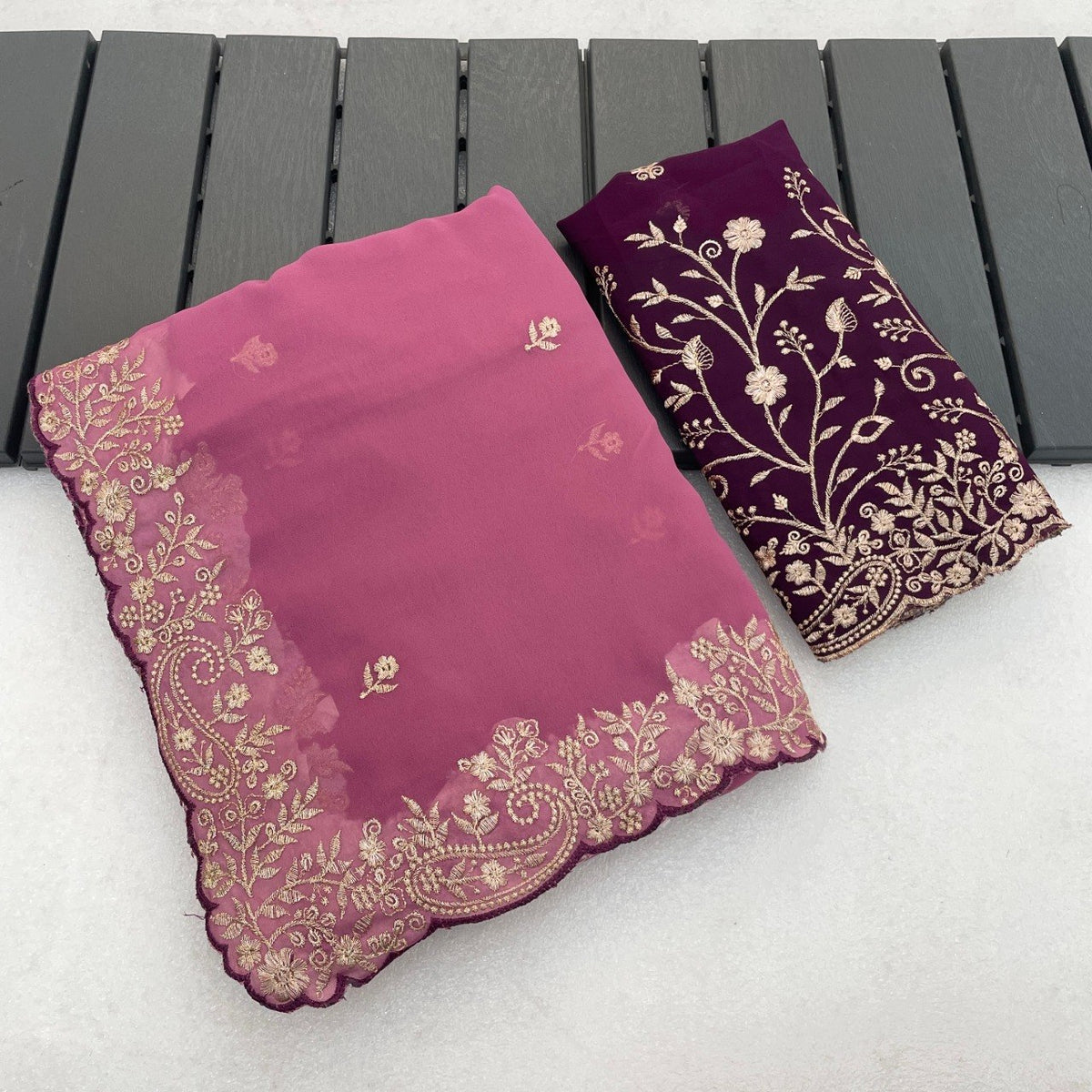 Rose pink Georgette saree flatlay with floral embroidered border and matching blouse — Chandrikas