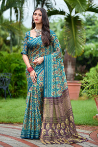 Woman in standing pose wearing teal blue leaf print cotton saree with brown pallu — Chandrikas