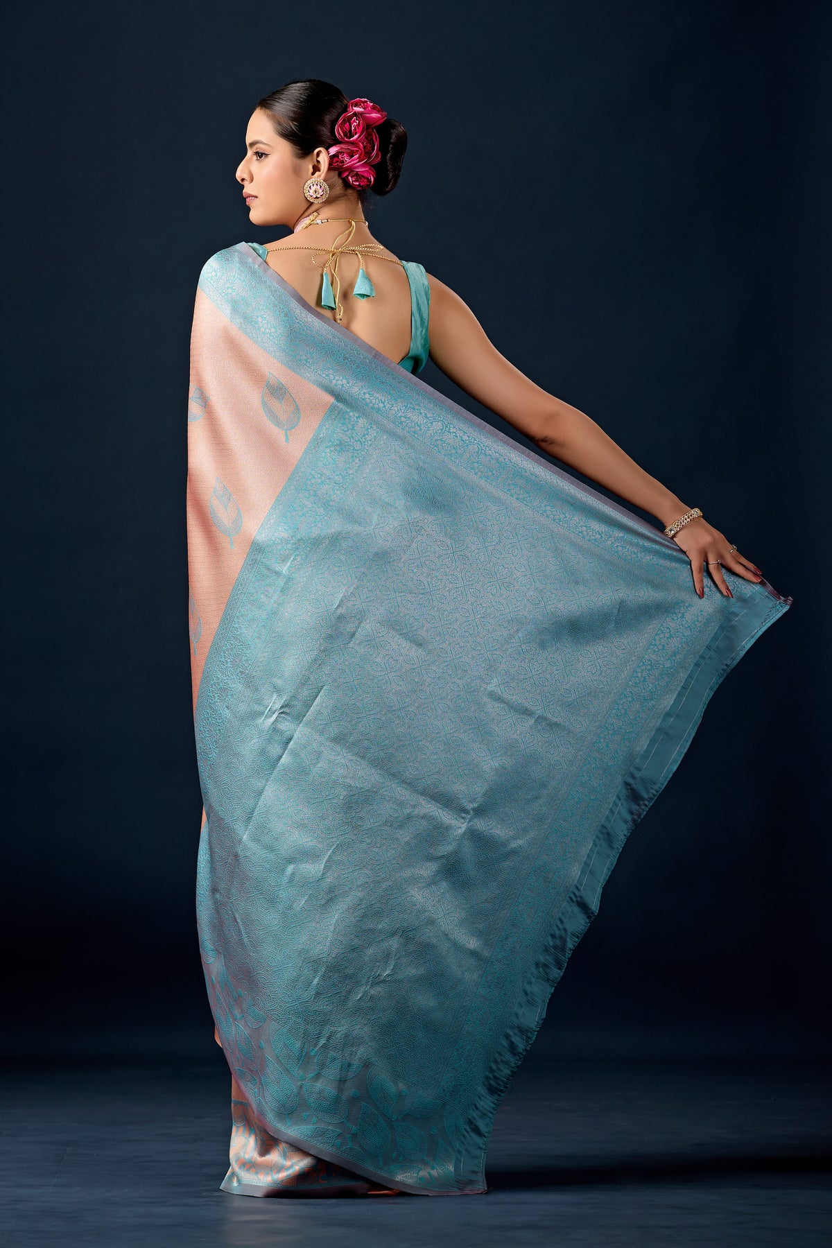 Woman draping beige cream teal leaf motif zari pallu silk saree showing pallu design — Chandrikas