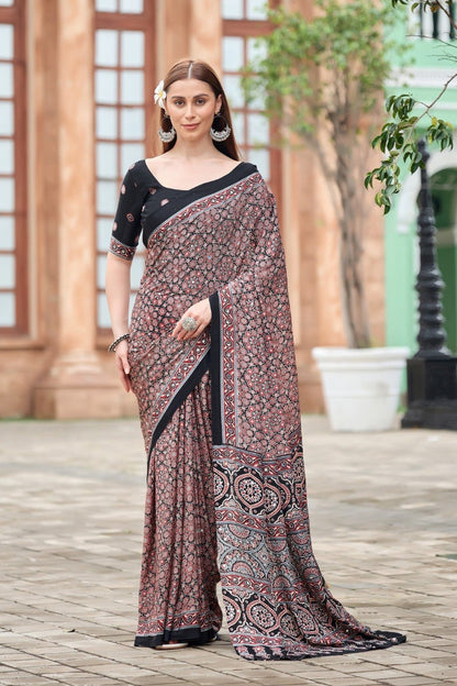 Woman wearing a black Ajrakh print mirror work Italian crepe saree with floral border and matching blouse — Chandrikas