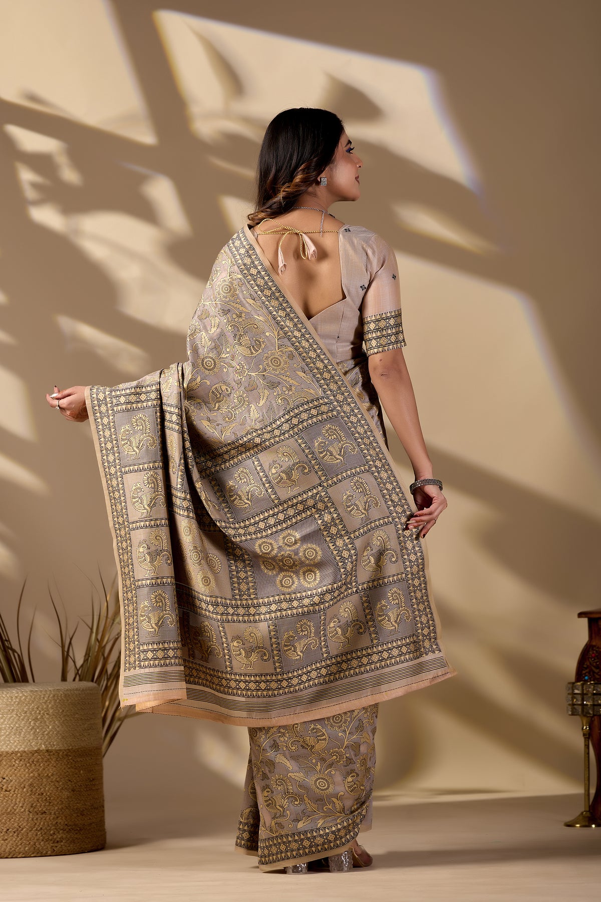 Woman draping classic beige Banarasi cotton jacquard jaal saree showing pallu motif — Chandrikas