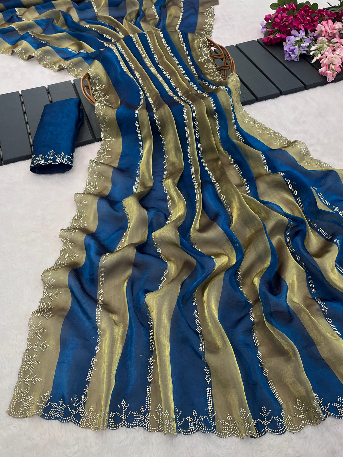 Closeup of cobalt blue striped satin patta saree flatlay showing golden border detail — Chandrikas