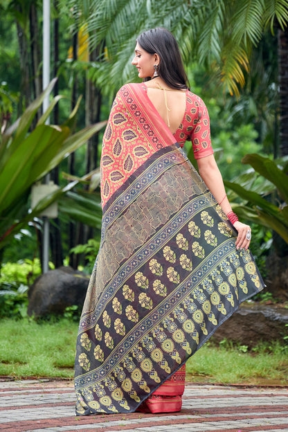 Woman in back pose wearing coral red leaf print cotton saree with grey border — Chandrikas