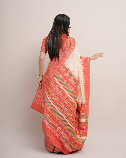 Woman in back pose showing pallu of cream coral Assam cotton silk saree with temple border — Chandrikas