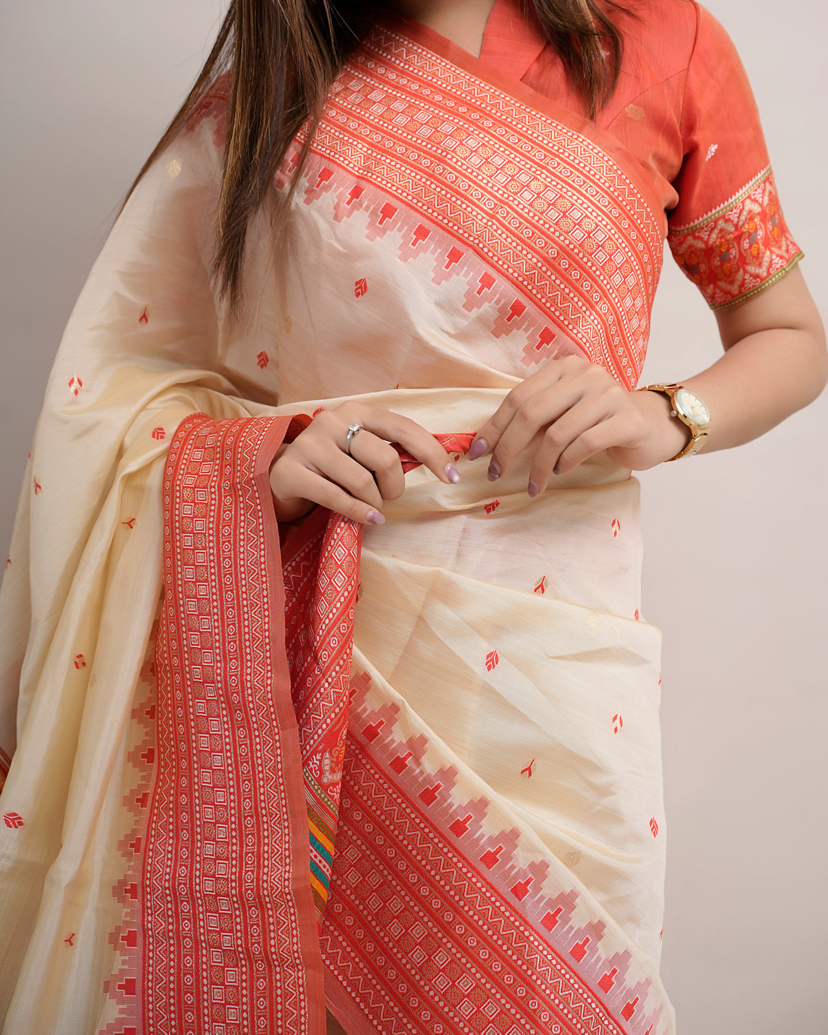 Close pose showing colourful micro butis and temple border of cream coral Assam cotton silk saree — Chandrikas