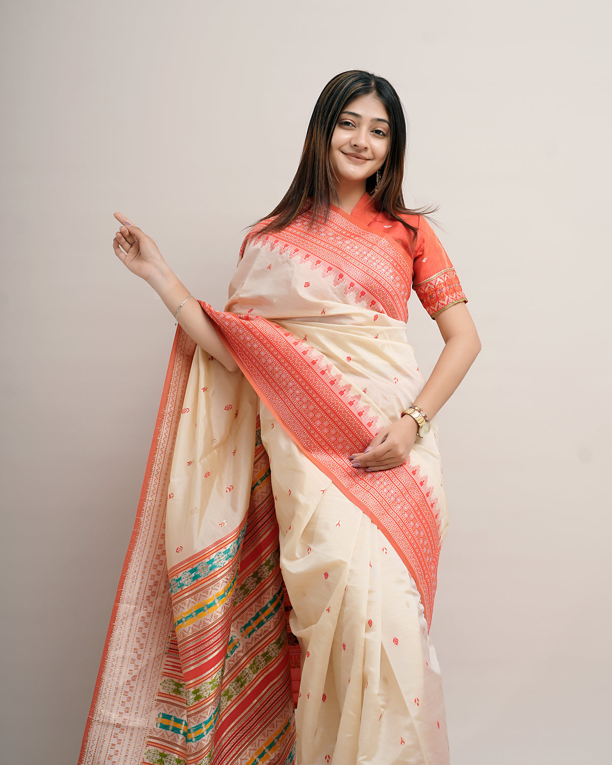 Woman in front pose wearing cream coral Assam cotton silk saree with temple border and rosette pallu — Chandrikas