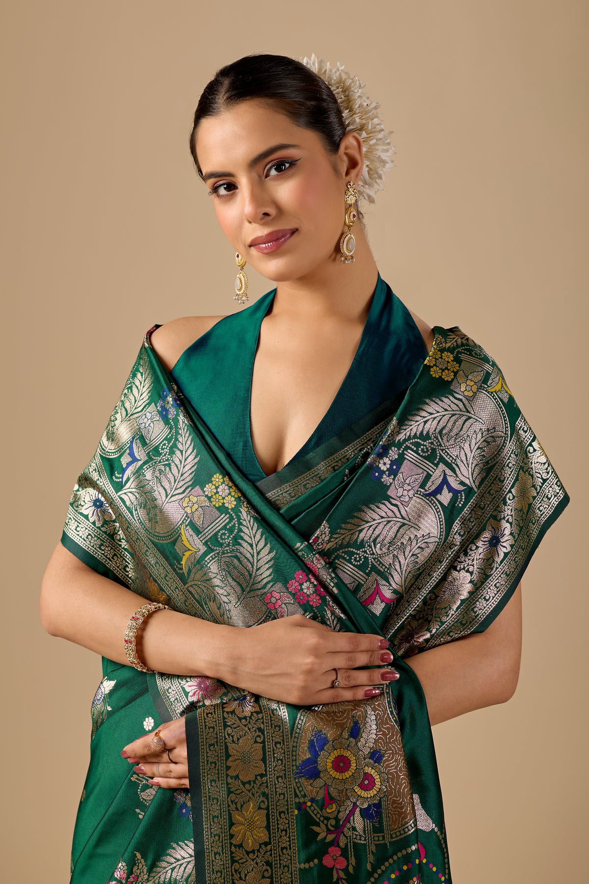 Woman in close pose wearing deep green Meenakari deer motif zari pallu silk saree — Chandrikas