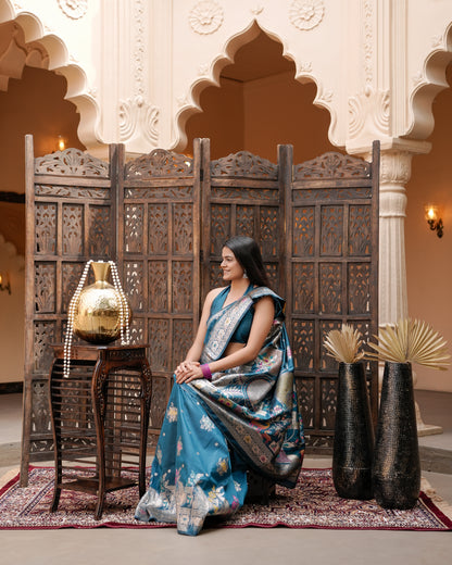 Woman seated showing pallu of deep teal blue Meenakari deer motif zari pallu silk saree — Chandrikas
