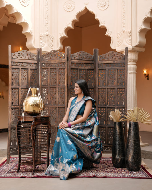 Woman seated showing pallu of deep teal blue Meenakari deer motif zari pallu silk saree — Chandrikas