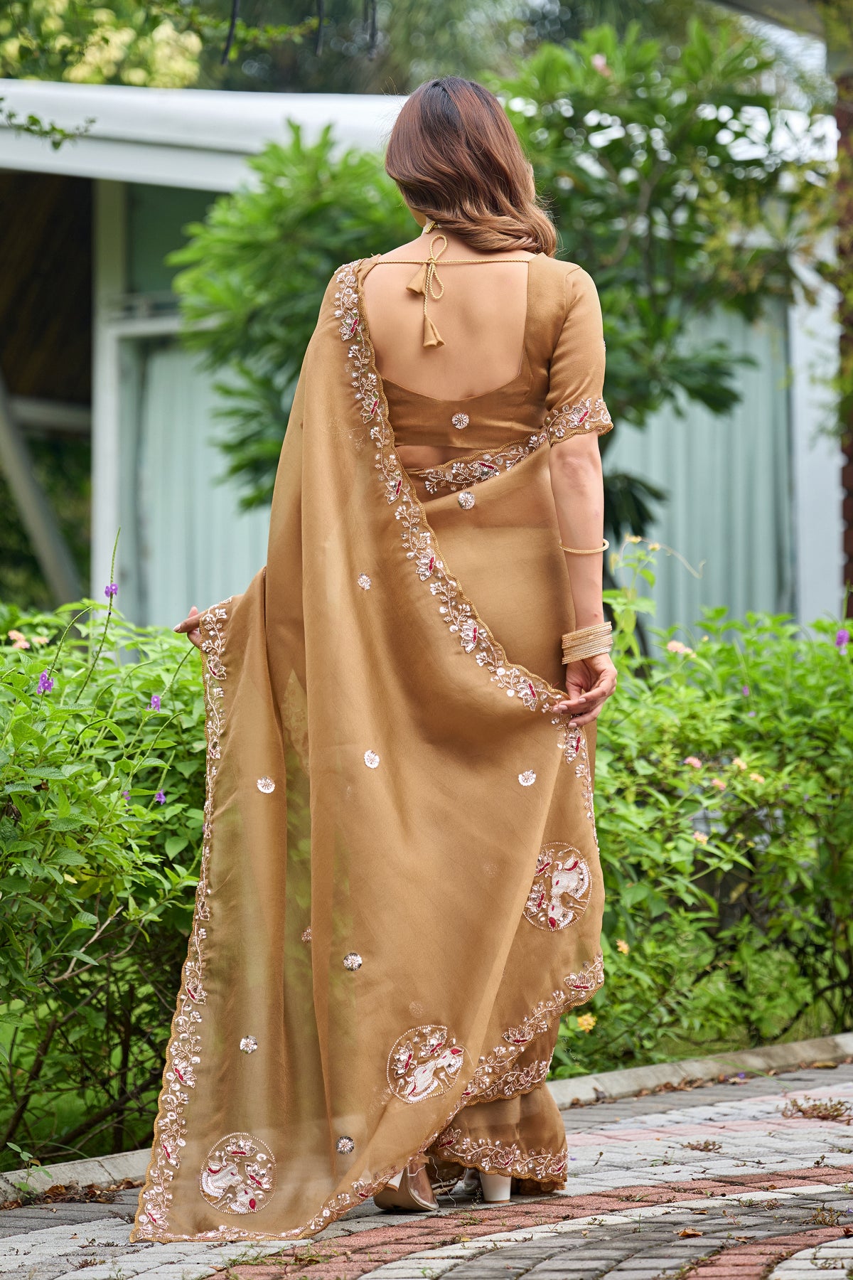 Woman in back pose wearing dusty gold sequin floral embroidered tissue silk saree showing pallu — Chandrikas