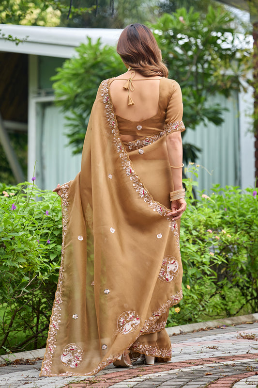 Woman in back pose wearing dusty gold sequin floral embroidered tissue silk saree showing pallu — Chandrikas