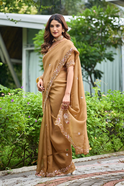 Woman in side pose wearing dusty gold sequin floral embroidered tissue silk saree with embroidered border — Chandrikas