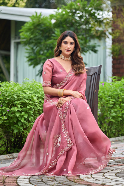 Woman in side pose wearing dusty pink sequin floral embroidered tissue silk saree with border — Chandrikas