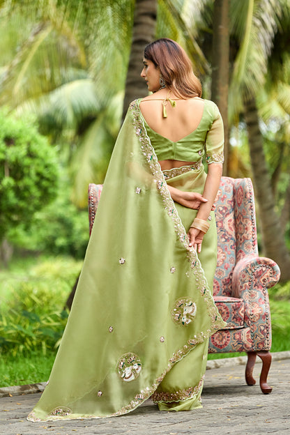 Woman in back pose wearing dusty pista sequin floral embroidered tissue silk saree showing pallu — Chandrikas