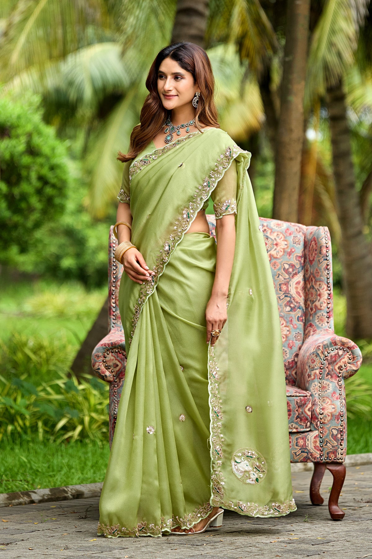 Woman in side pose wearing dusty pista sequin floral embroidered tissue silk saree with border — Chandrikas