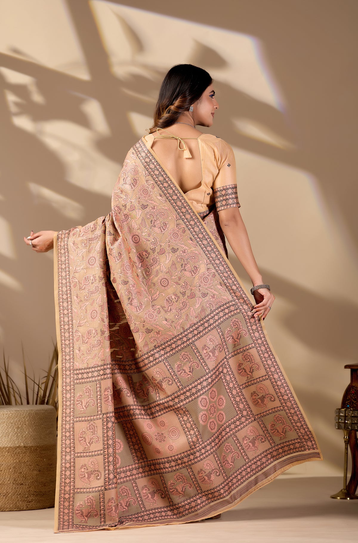 Woman draping dusty rose Banarasi cotton jacquard jaal saree showing pallu motif — Chandrikas
