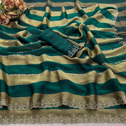 Emerald green striped satin patta saree flatlay with golden border and embellished edge — Chandrikas