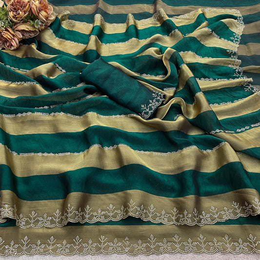 Emerald green striped satin patta saree flatlay with golden border and embellished edge — Chandrikas