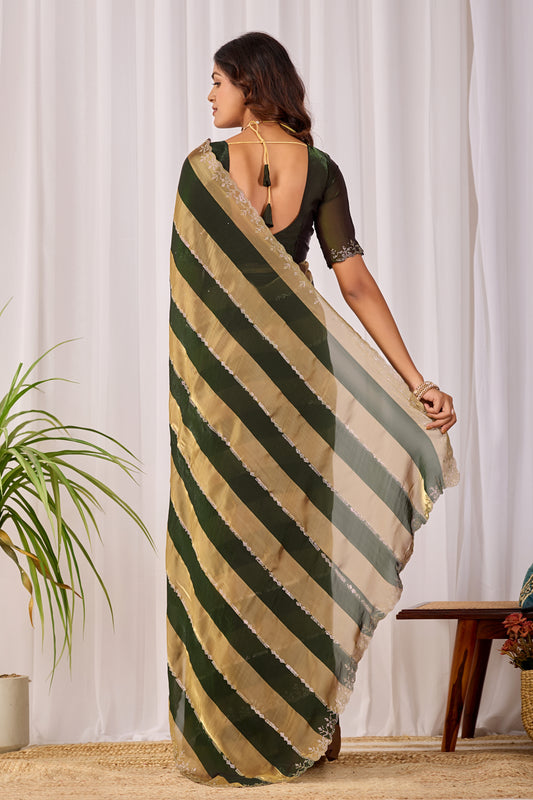 Woman in back pose wearing fern green striped satin patta saree with golden border — Chandrikas