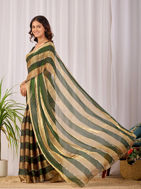 Woman in walking pose wearing fern green striped satin patta saree with golden pallu — Chandrikas