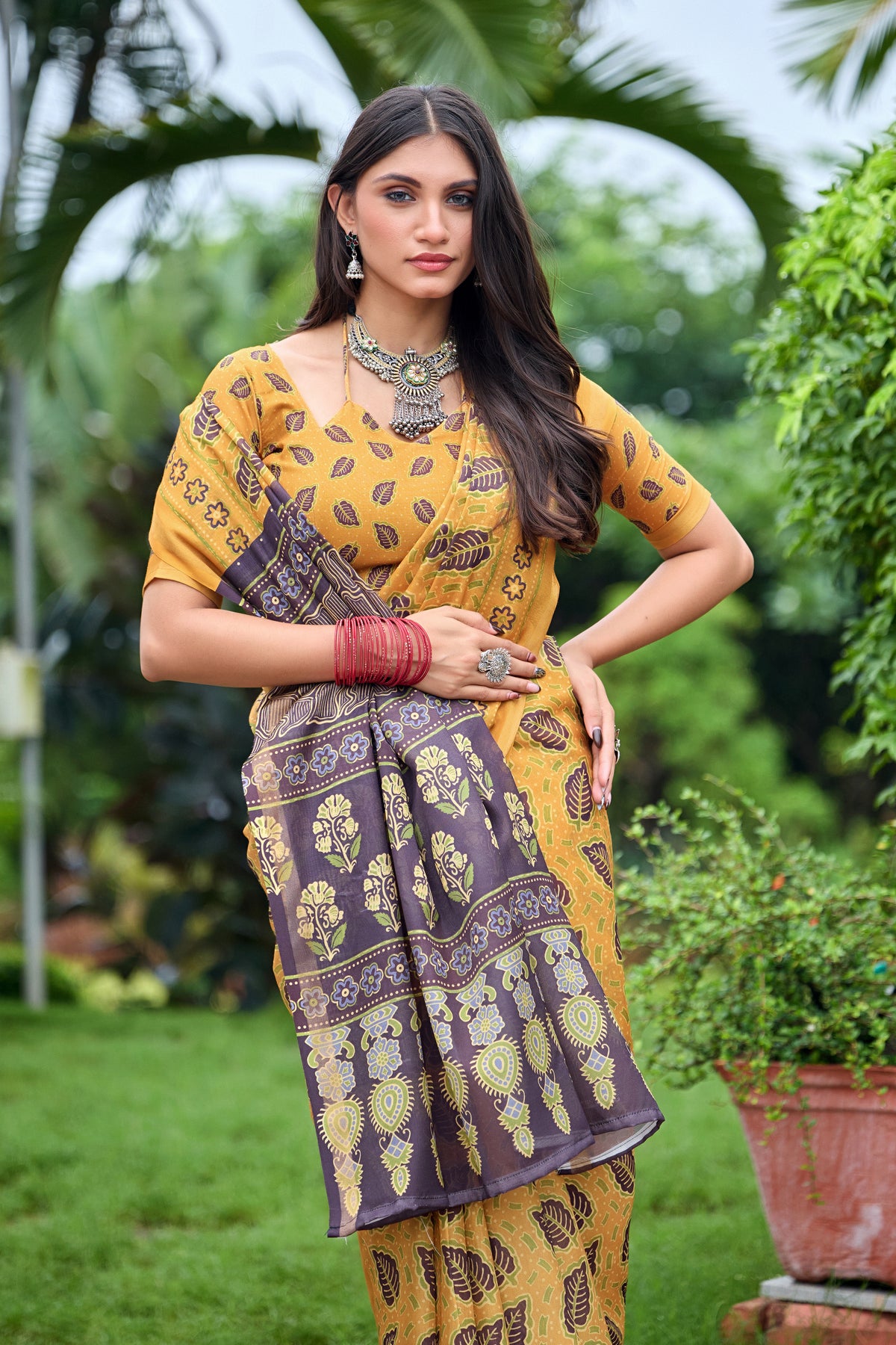 Woman in close pose wearing golden mustard leaf print cotton saree with brown border — Chandrikas