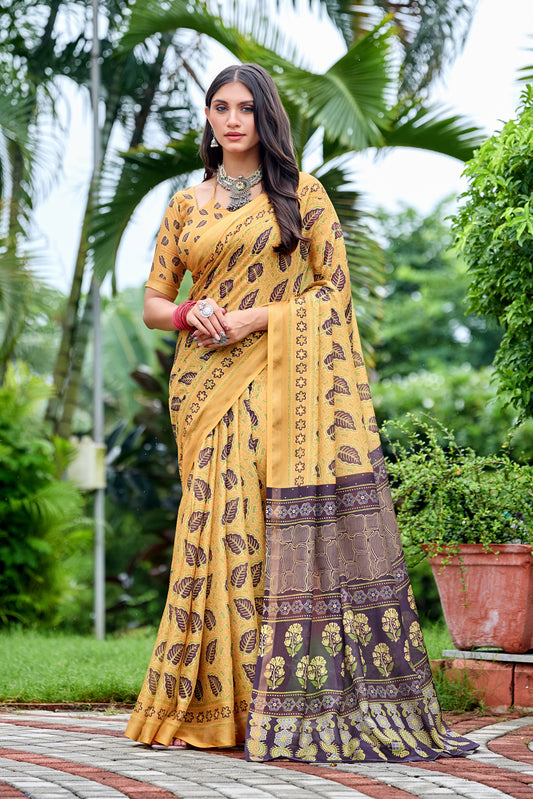 Woman in front pose wearing golden mustard leaf print cotton saree with brown border — Chandrikas