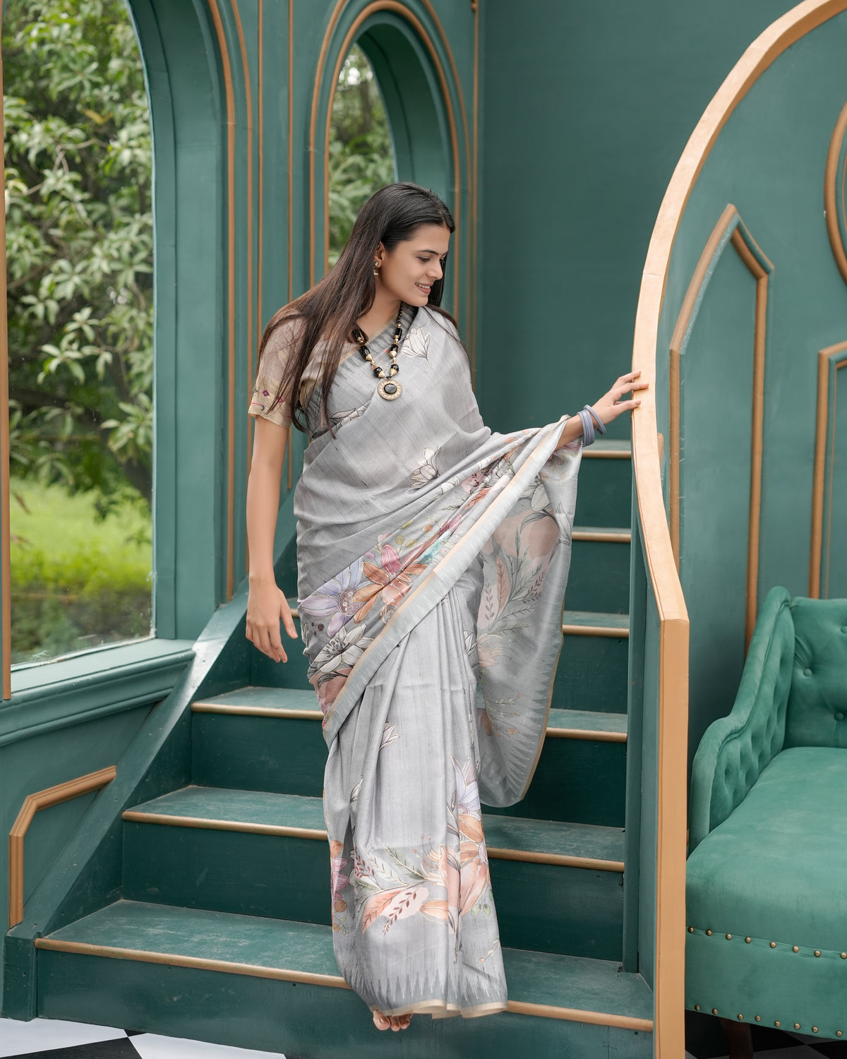 Woman on staircase wearing grey woven lotus floral digital print cotton saree — Chandrikas