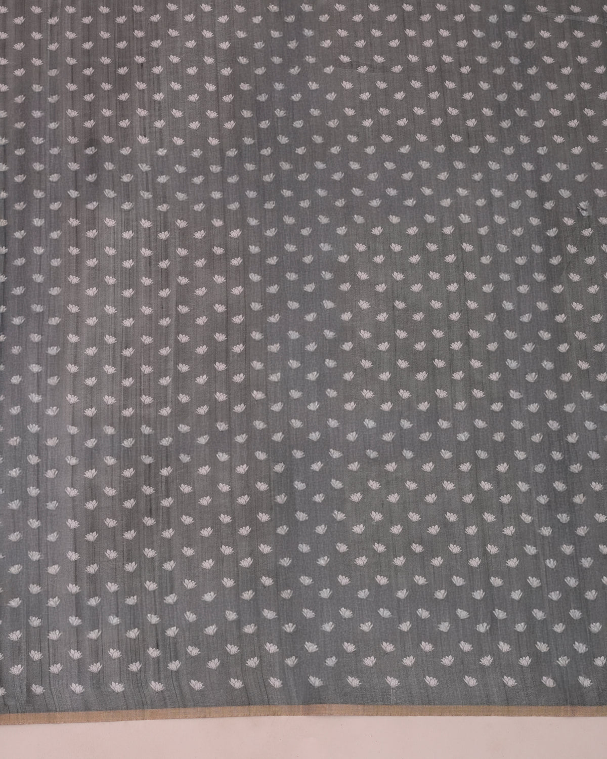 Close-up of grey cotton saree showing woven lotus floral buttis pattern — Chandrikas
