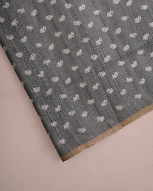 Close-up of grey cotton saree fabric showing woven lotus floral buttis and gold border — Chandrikas