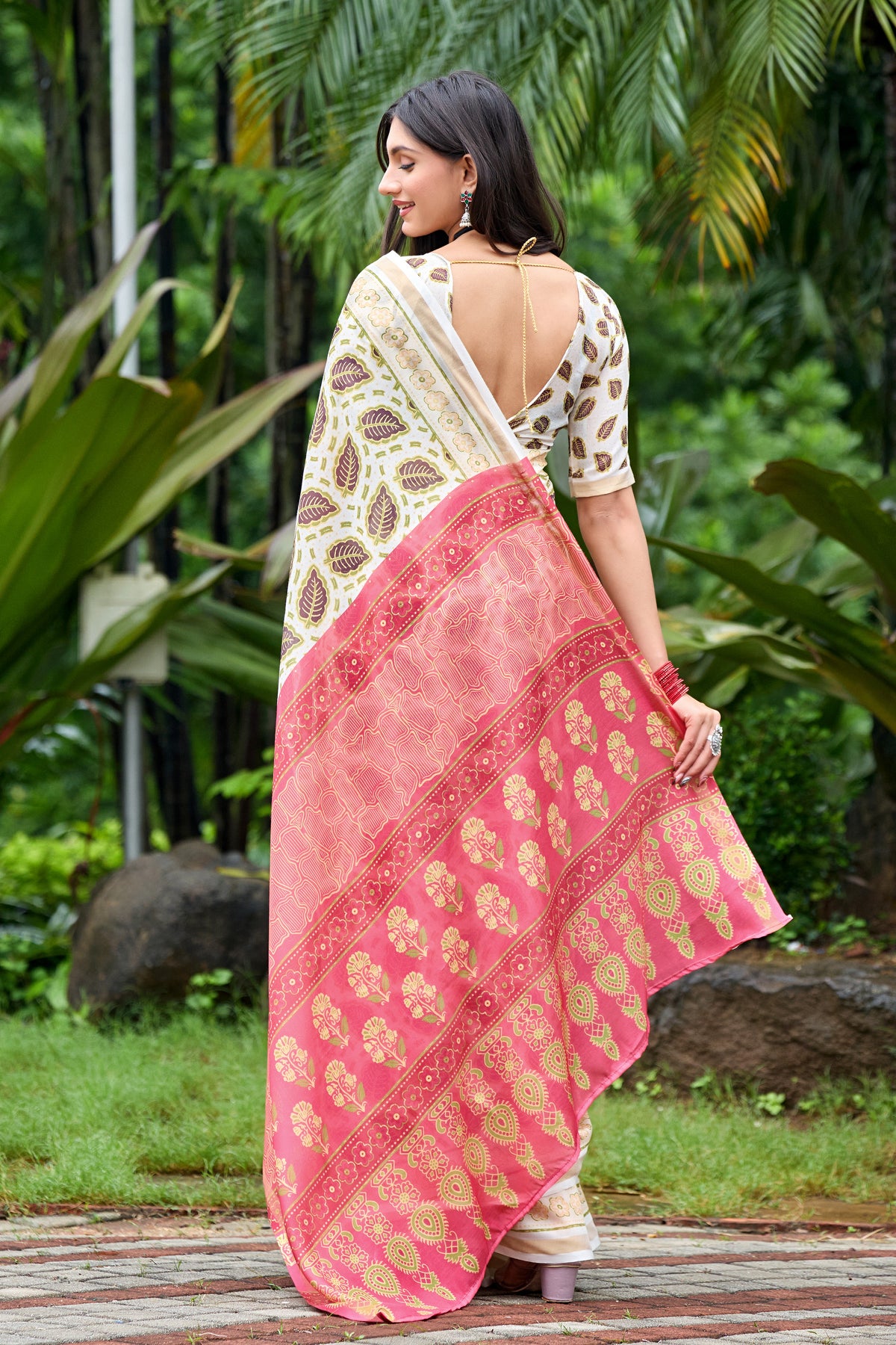 Woman in back pose wearing ivory cream leaf print cotton saree with pink border — Chandrikas