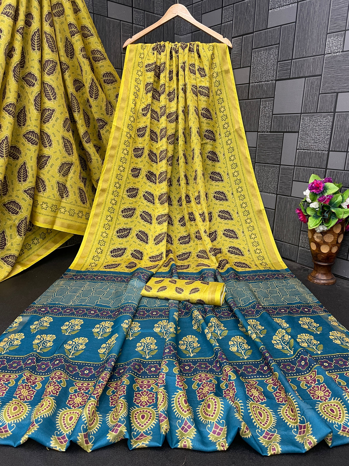 Lemon yellow leaf print cotton saree flatlay with blue border and matching blouse — Chandrikas
