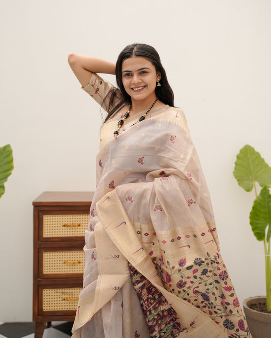 Woman draping light beige Banarasi-Paithani Meenakari cotton zari pallu saree showing peacock motif — Chandrikas