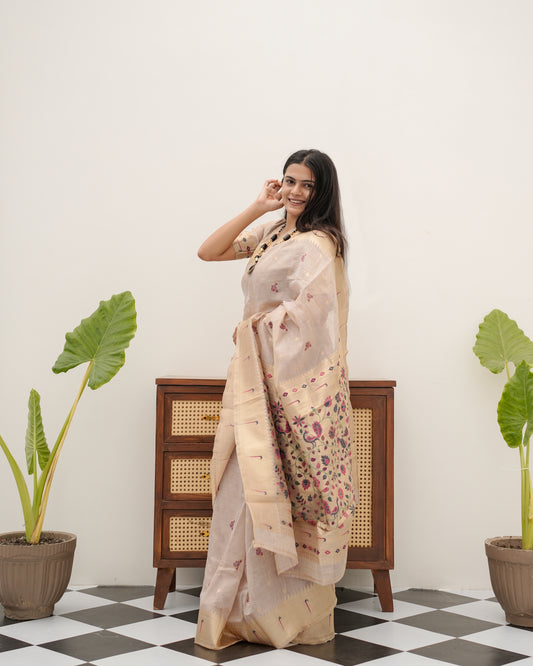 Woman in side pose wearing light beige Banarasi-Paithani Meenakari cotton zari pallu saree — Chandrikas