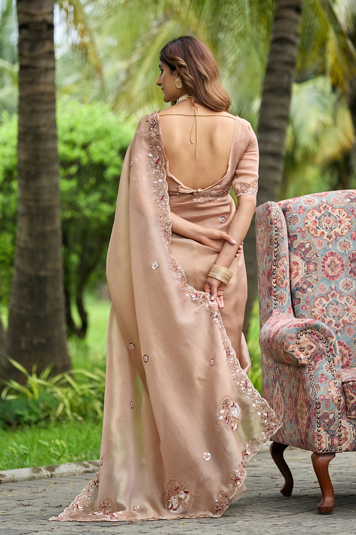 Woman in back pose wearing light chicku sequin floral embroidered tissue silk saree showing pallu — Chandrikas