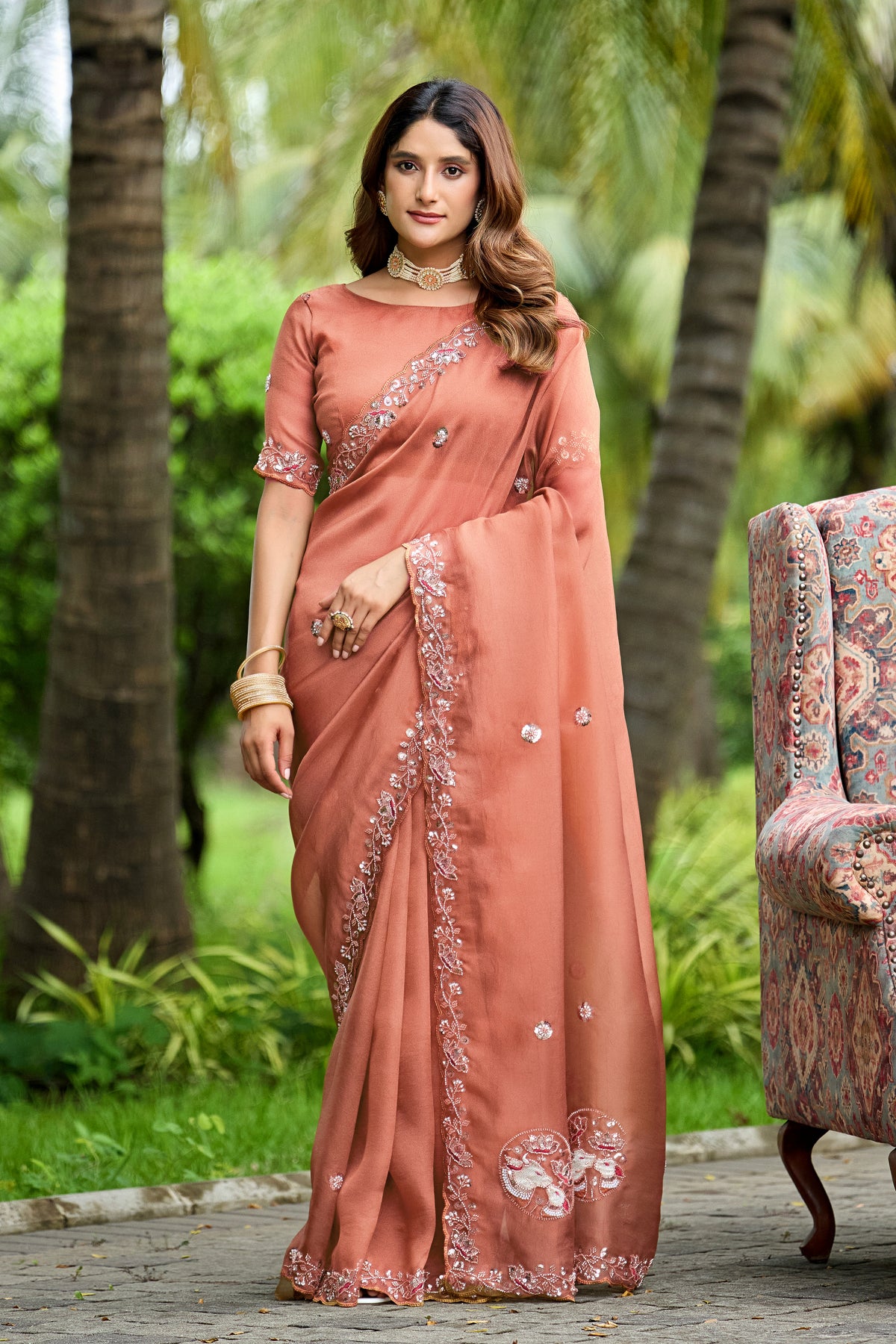 Woman standing in front pose wearing light gajri sequin floral embroidered tissue silk saree — Chandrikas