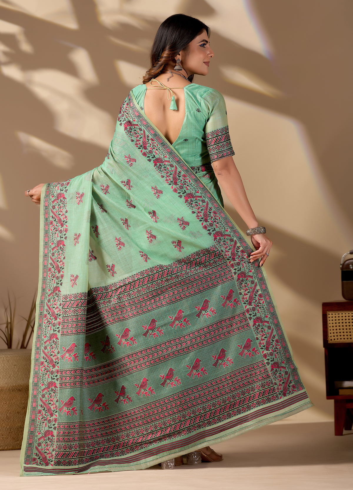 Woman draping light green Banarasi cotton jacquard bird buttis saree showing pallu motif — Chandrikas
