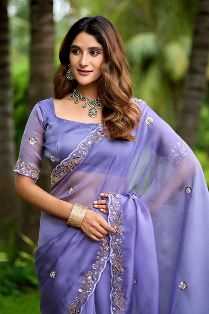Side pose wearing light lavender sequin floral embroidered tissue silk saree showing embroidered border — Chandrikas