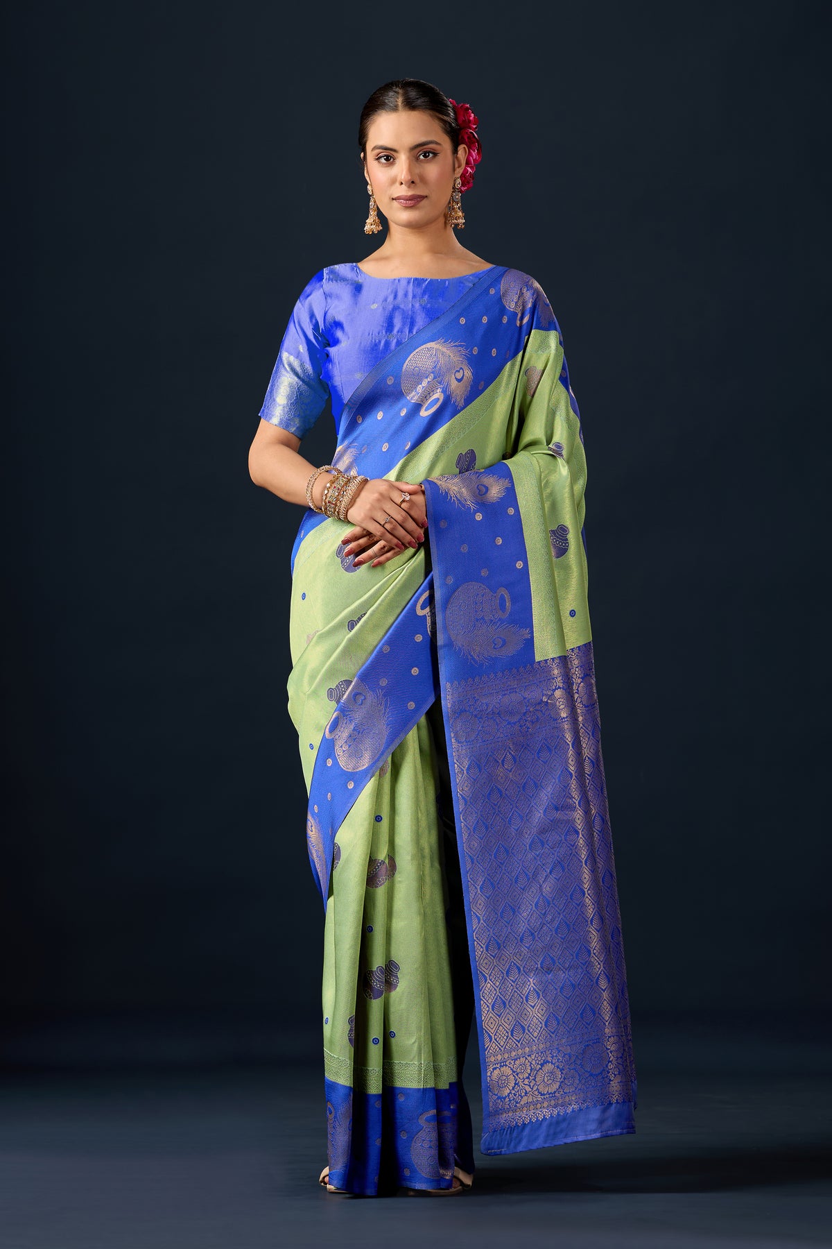 Woman in front pose wearing light olive green blue silk matka motif border saree — Chandrikas