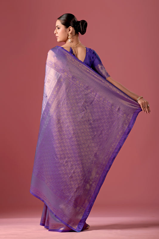 Woman draping light purple deep purple Banarasi silk checks pattern saree showing pallu design — Chandrikas