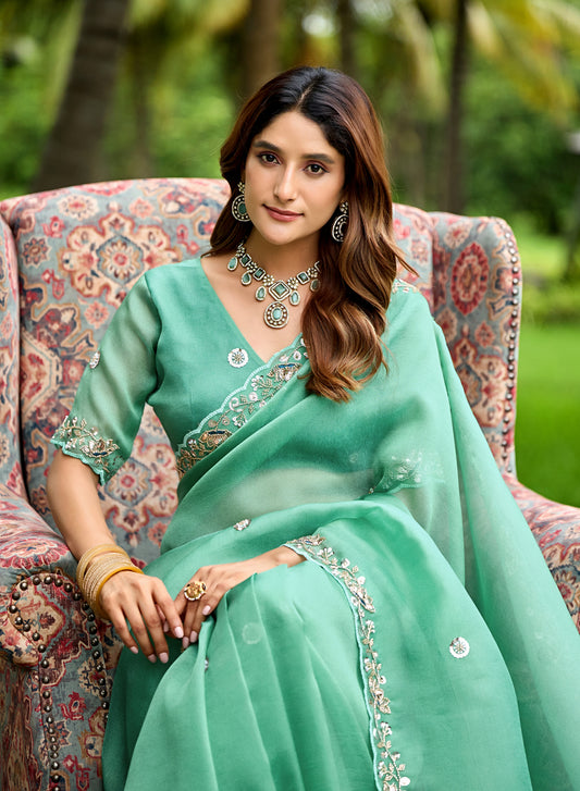 Woman in sitting pose wearing light rama sequin floral embroidered tissue silk saree — Chandrikas