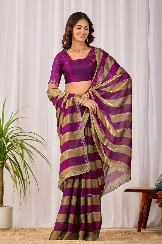 Woman in standing pose wearing magenta purple striped satin patta saree with golden border — Chandrikas