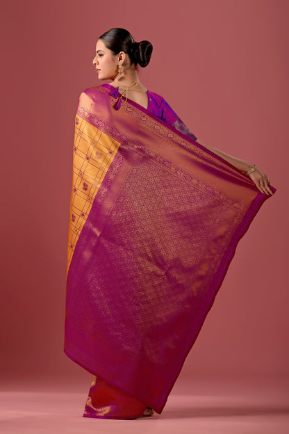 Woman draping mango yellow pink Banarasi silk checks pattern saree showing pallu design — Chandrikas