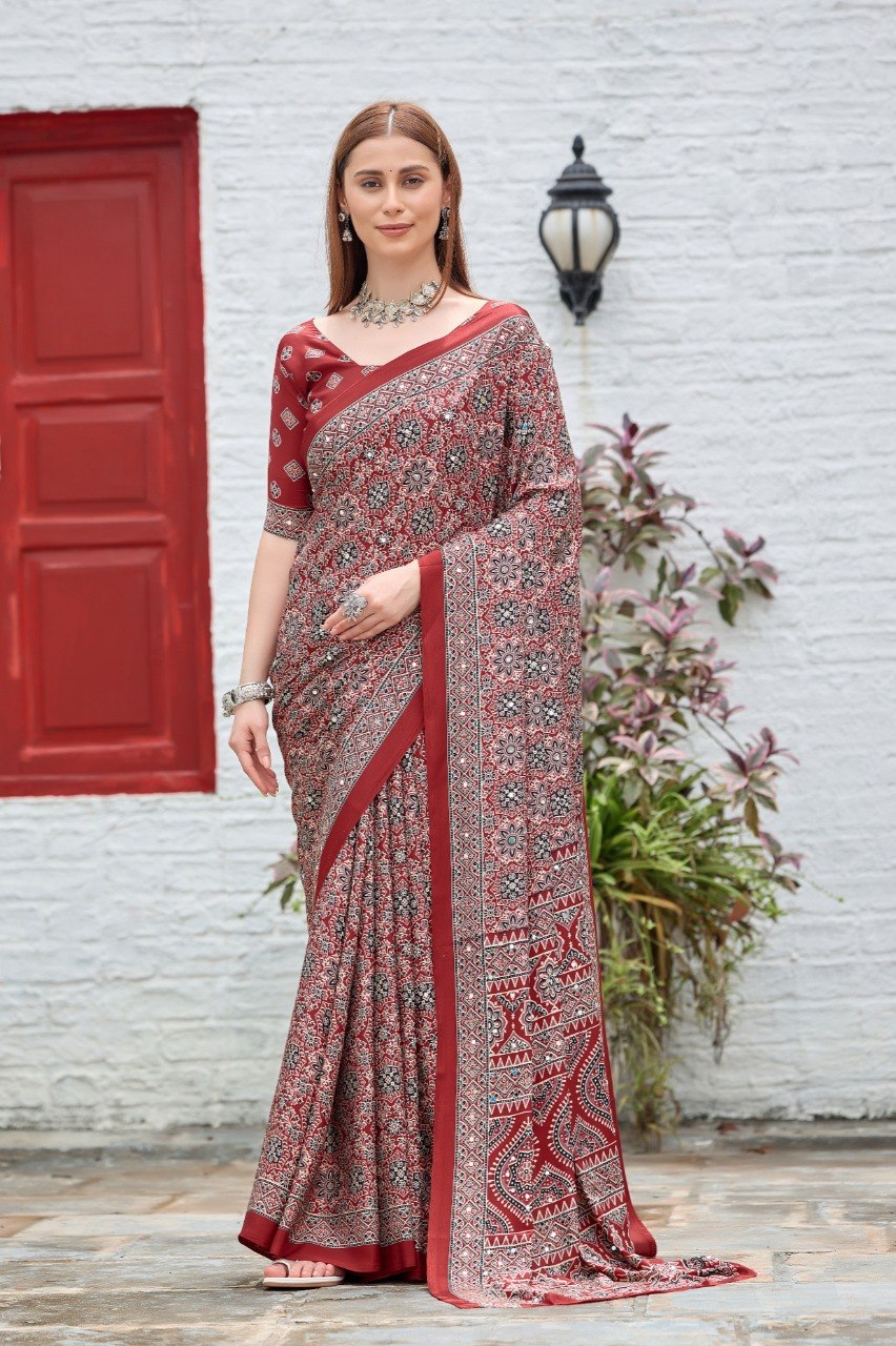 Woman wearing a maroon Ajrakh print mirror work Italian crepe saree with matching blouse — Chandrikas