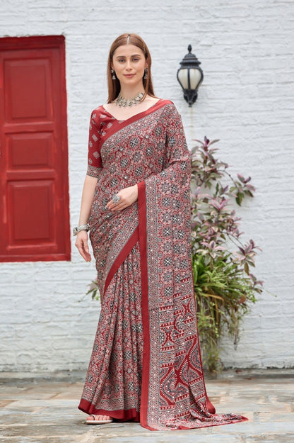 Woman wearing a maroon Ajrakh print mirror work Italian crepe saree with matching blouse — Chandrikas