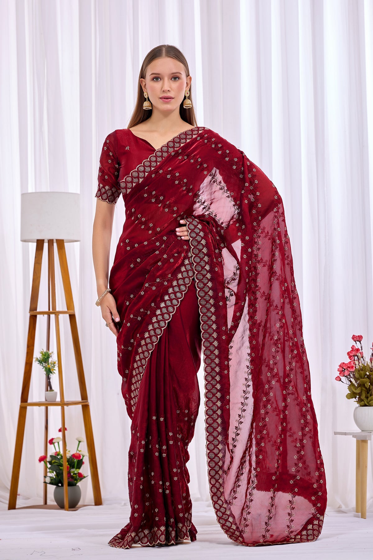 Side pose showing pleats and border of Maroon satin floral thread work designer border saree — Chandrikas