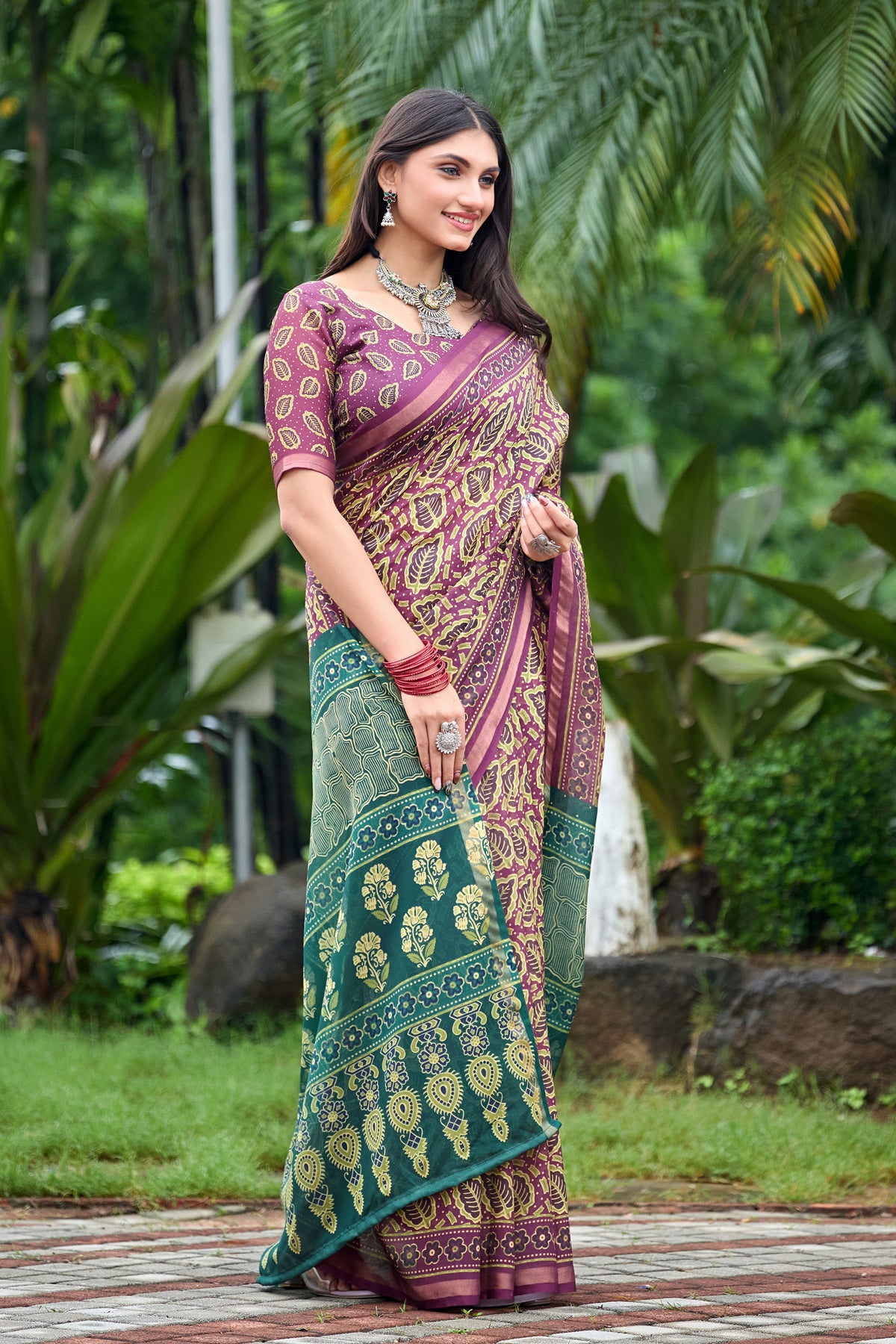 Woman in front pose wearing mauve purple leaf print cotton saree with teal border — Chandrikas