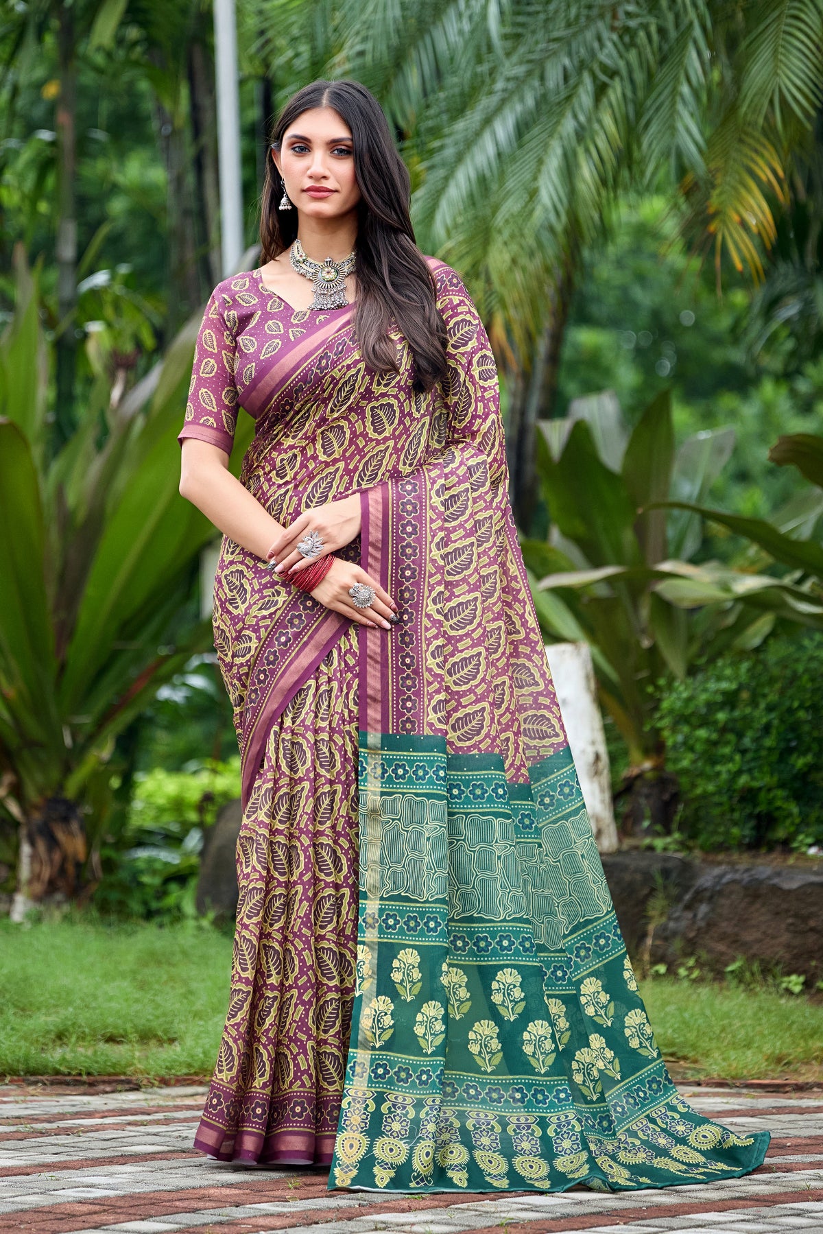 Woman in side pose wearing mauve purple leaf print cotton saree with teal border — Chandrikas